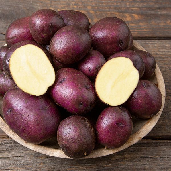 Blue potatoes in a wooden bowl.